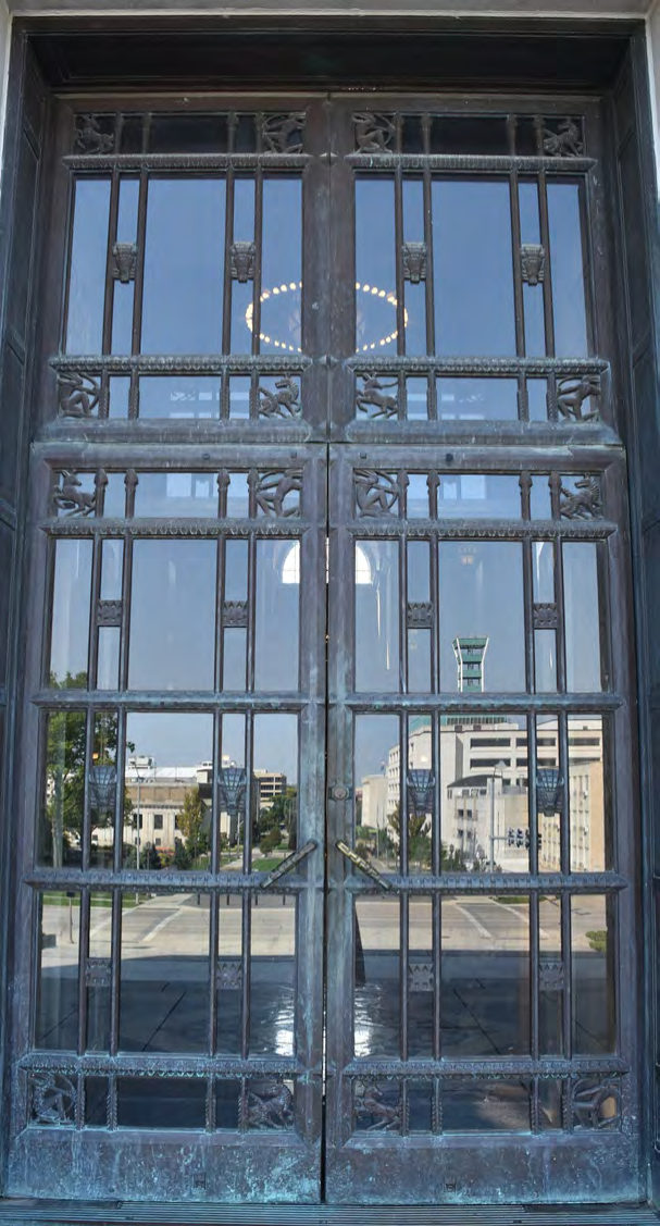 The bronze entrance doors have motifs of bison