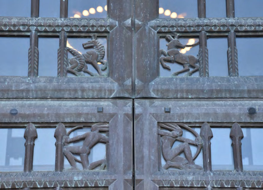 The bronze entrance doors have motifs of bison