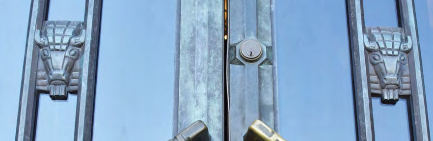 The bronze entrance doors have motifs of bison