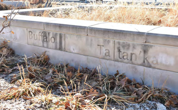 Limestone walls along the stepped plaza are engraved
